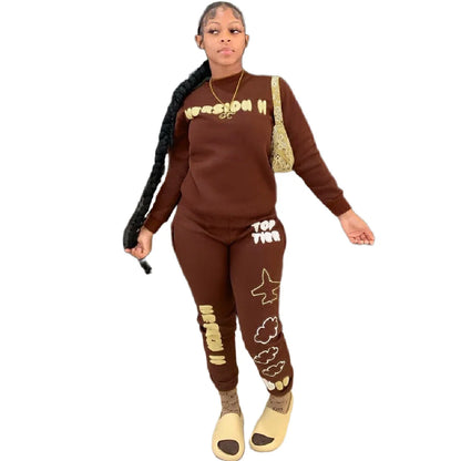 Stylish two-piece casual sports outfit for women, featuring a relaxed top and comfortable trousers in black and brown colors.
