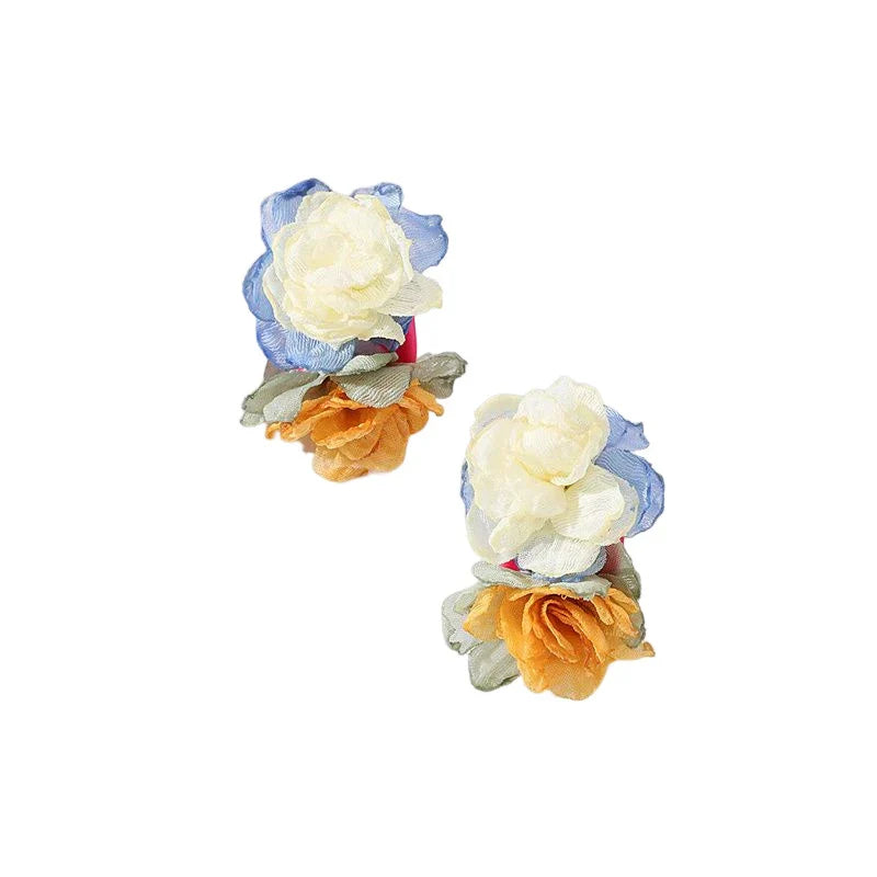 Exquisite handcrafted floral earrings with delicate fabric flowers and alloy accents, showcasing timeless British elegance