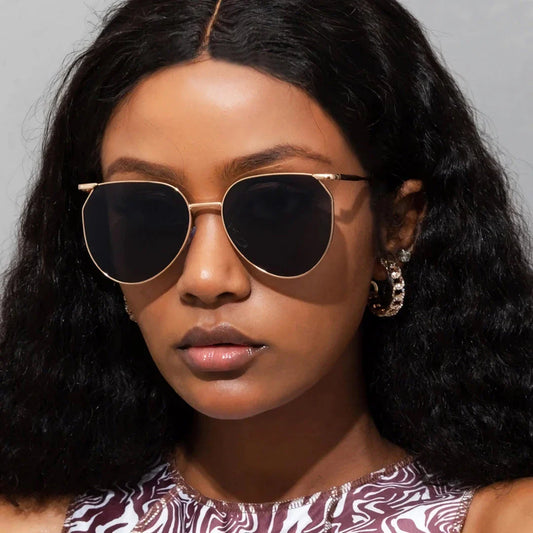 Elegant oval-shaped sunglasses with gradient lenses and alloy frames, offering timeless British style and UV protection.
