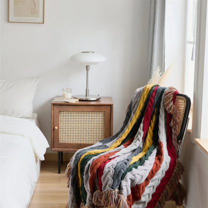 Elegant wool blanket with stylish plaid pattern and fringed tassels, perfect for cosy home decor and outdoor adventures.