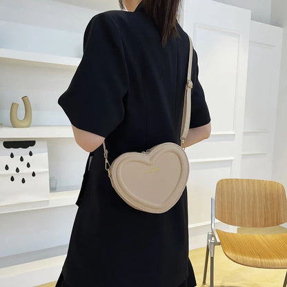 Chic heart-shaped crossbody bag made from premium PU leather, available in multiple stylish colours