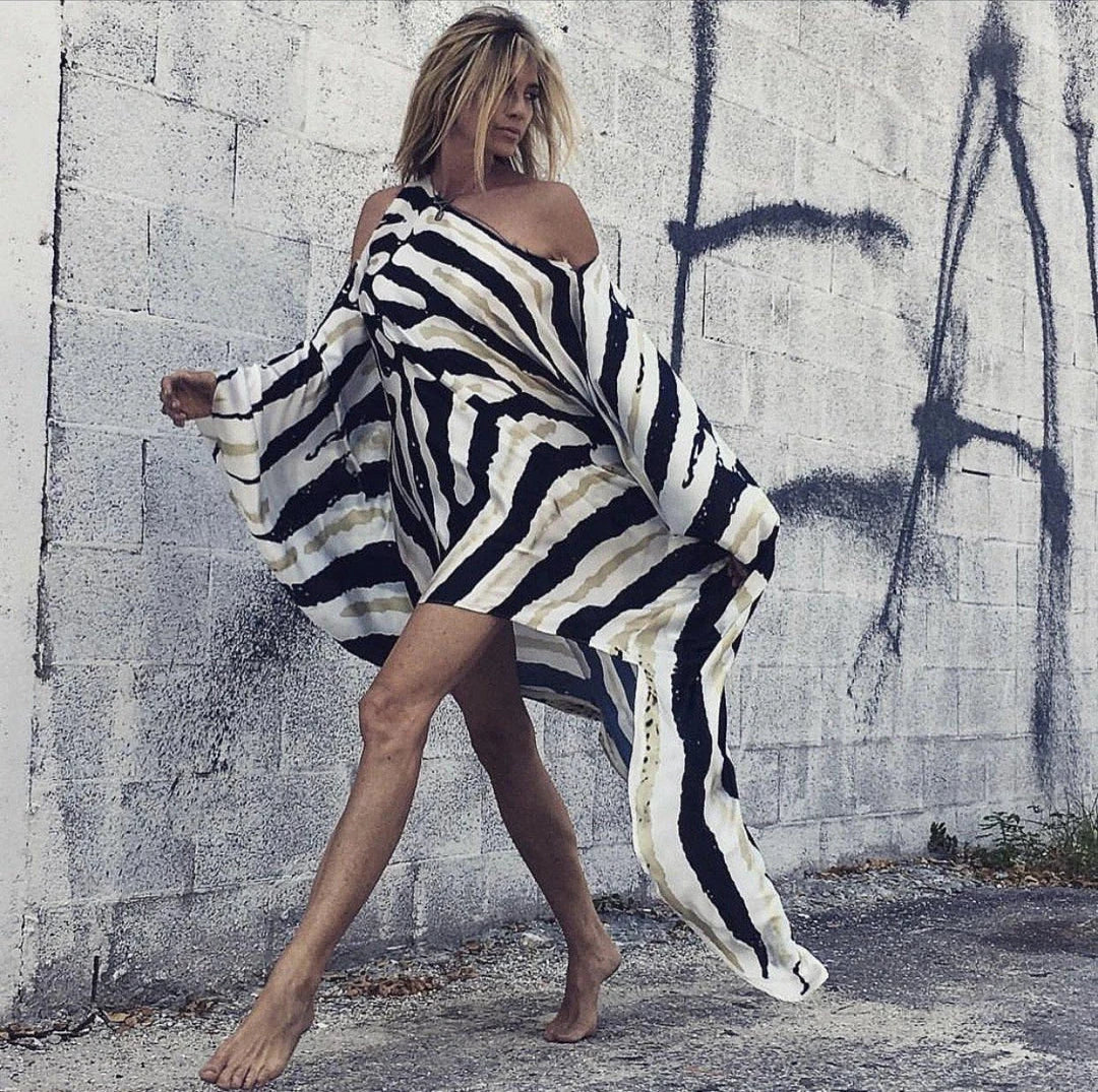 A chic inclined shoulder printed dress in a vibrant colour with a large, swinging skirt