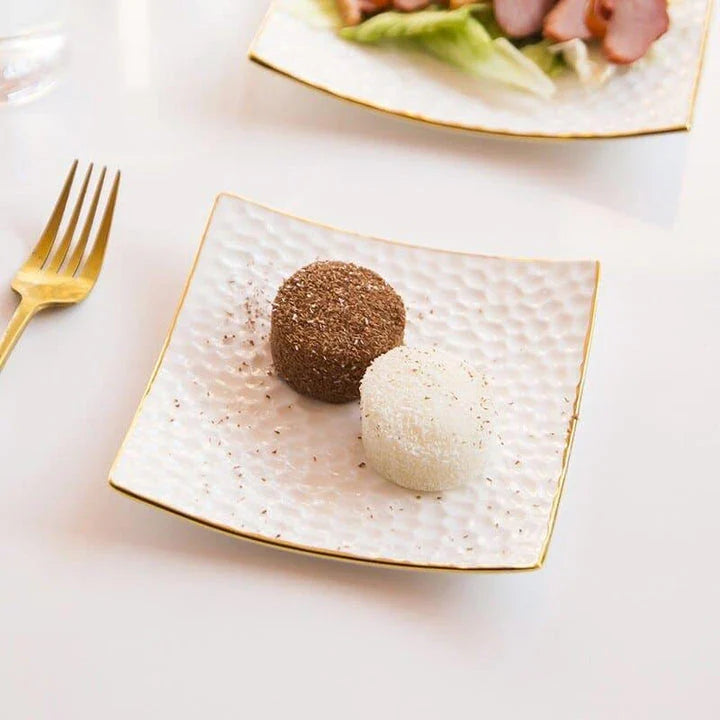 Elegant embossed ceramic cake plate in white, perfect for serving desserts and platters.