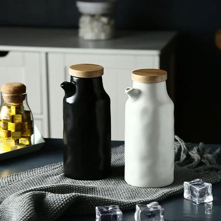 Premium black ceramic oil dispenser with a sleek and modern design, perfect for drizzling oils, vinegars, and sauces in the kitchen.