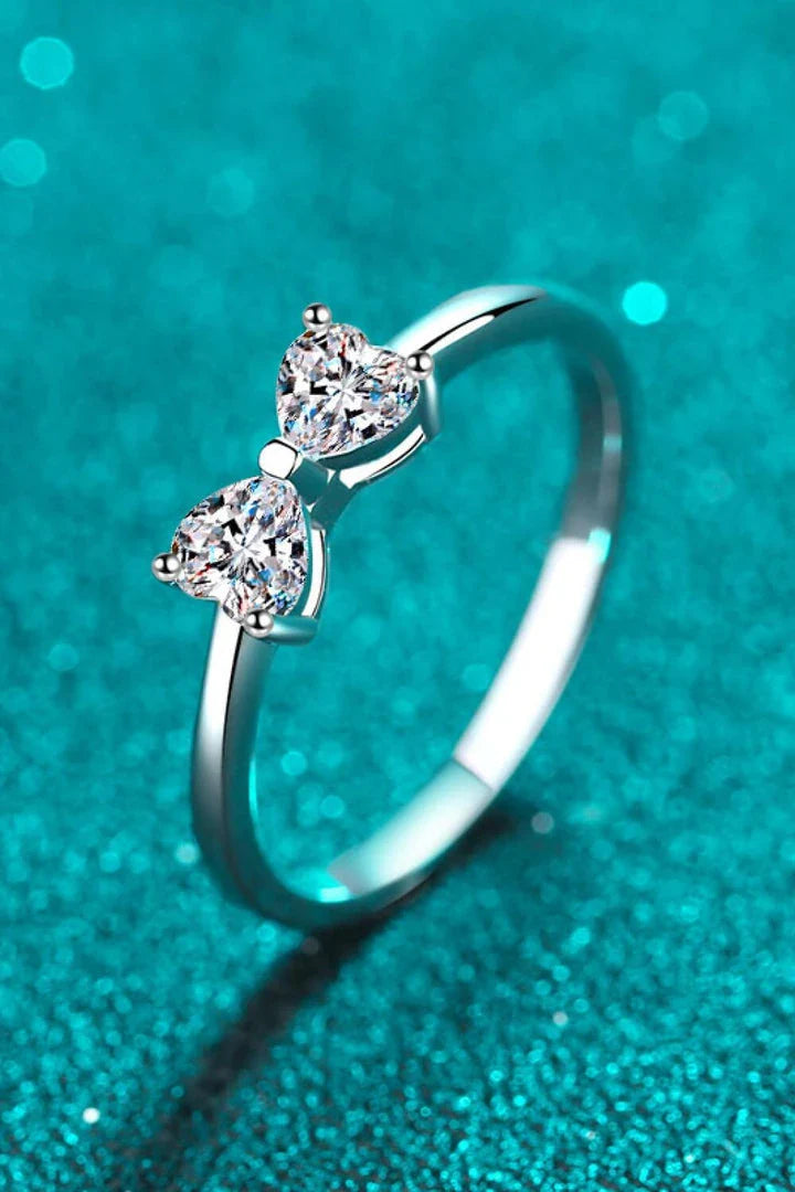 Elegant moissanite and sterling silver bow ring with a radiant, polished finish