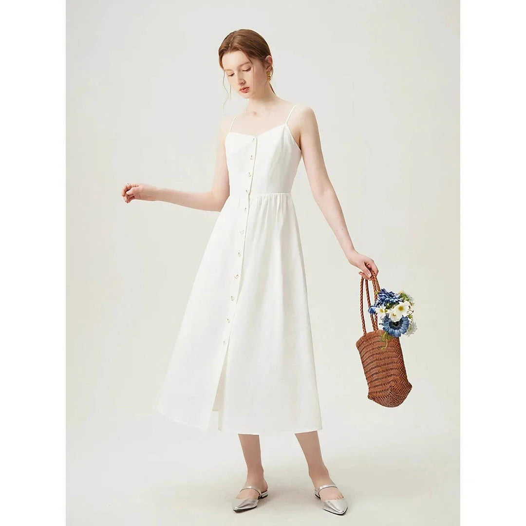 Elegant cotton and linen suspender dress with square collar neckline, A-line silhouette, and mid-calf length for a sophisticated and comfortable summer look.