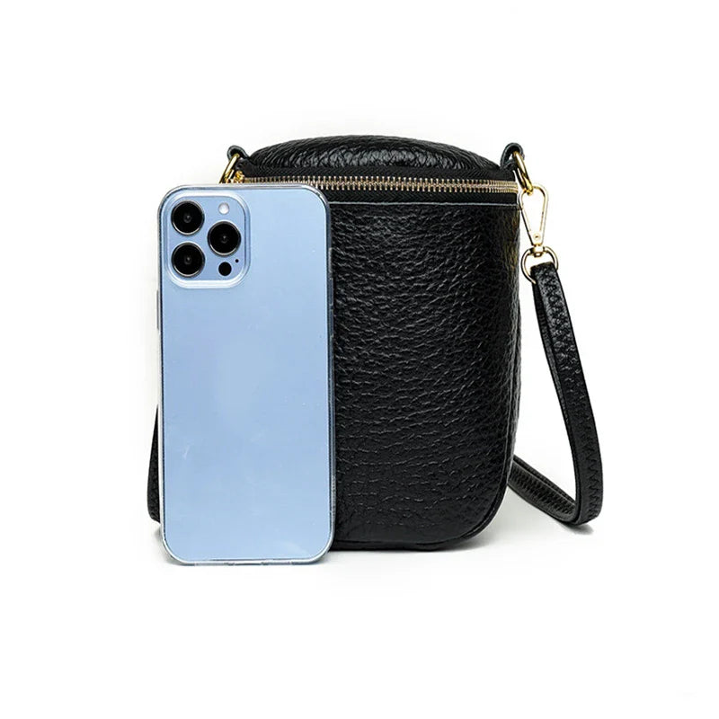 Elegant leather crossbody bag with adjustable strap, multiple pockets, and premium cowhide construction for the modern British woman