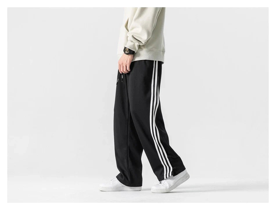 Stylish striped sports trousers in a relaxed, mid-waist design for versatile leisure and athletic wear