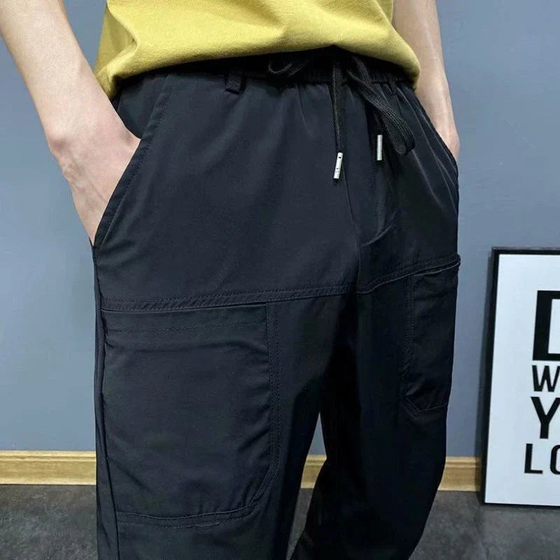 Premium slim-fit drawstring joggers in black and grey, featuring a tailored silhouette and adjustable waistband for a polished, comfortable look.
