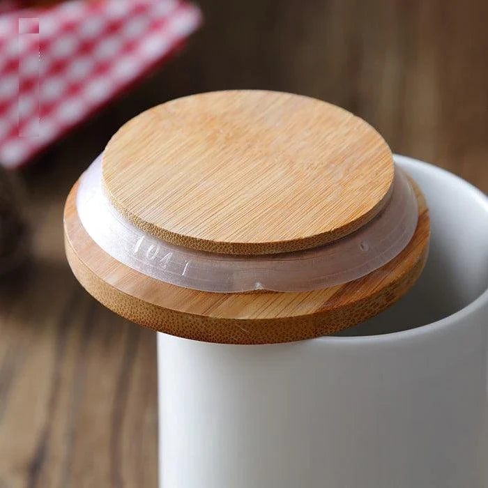 A ceramic kitchen jar with a bamboo lid, available in three sizes to suit your storage needs