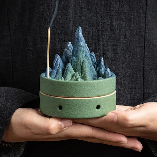 Elegant ceramic incense burner with a tranquil mountain and river design, creating a serene visual display