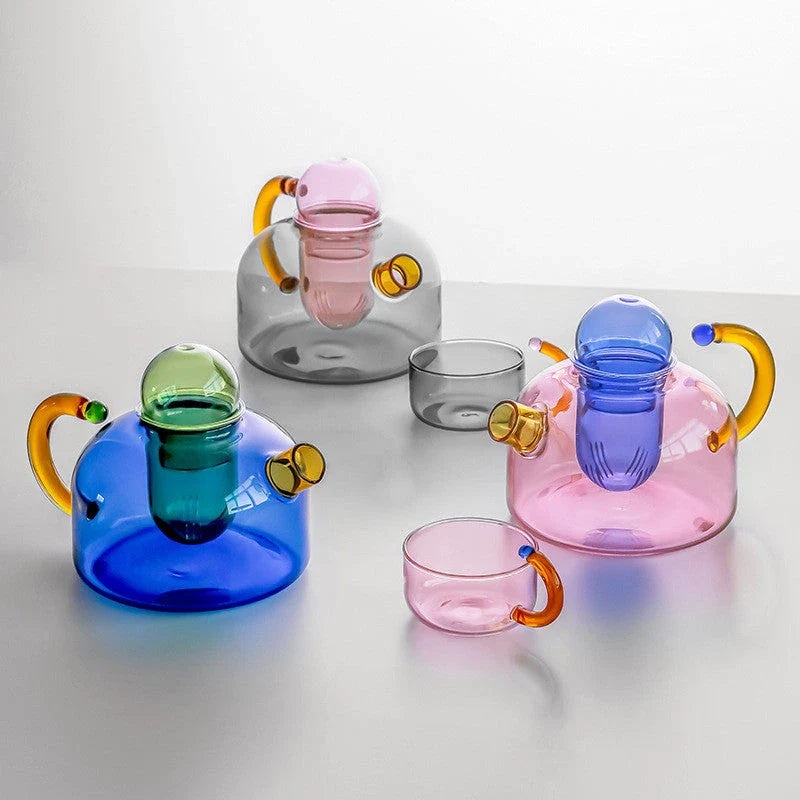 Elegant colourful glass teapot and teacup set with vibrant contrasting colours, perfect for tea and coffee enjoyment