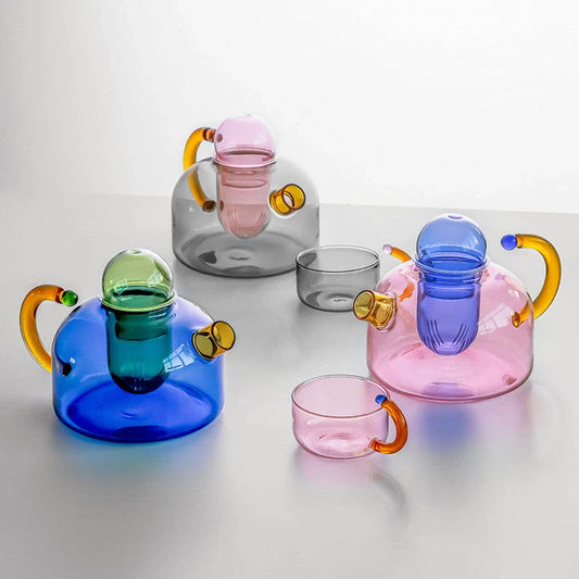 Elegant colourful glass teapot and teacup set with vibrant contrasting colours, perfect for tea and coffee enjoyment