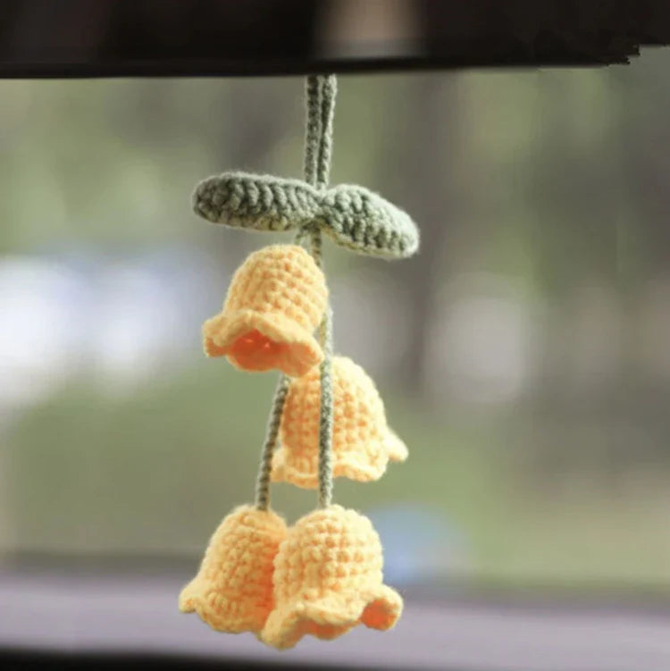 Charming knitted car plant decor with hanging white rope and green and white colour scheme