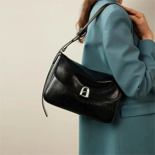 Stylish leather shoulder and crossbody bag in burgundy colour, with a square silhouette and sleek design