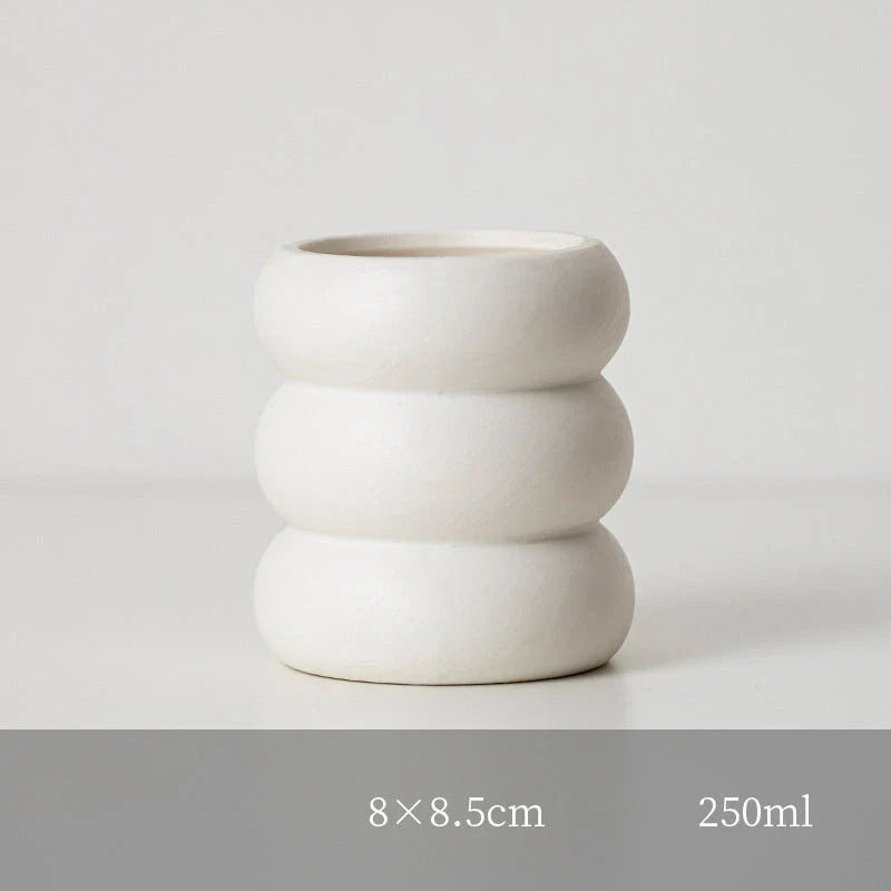 A white ceramic candlestick holder with a minimalist Nordic design, perfect for creating a cosy and sophisticated ambience in any room.