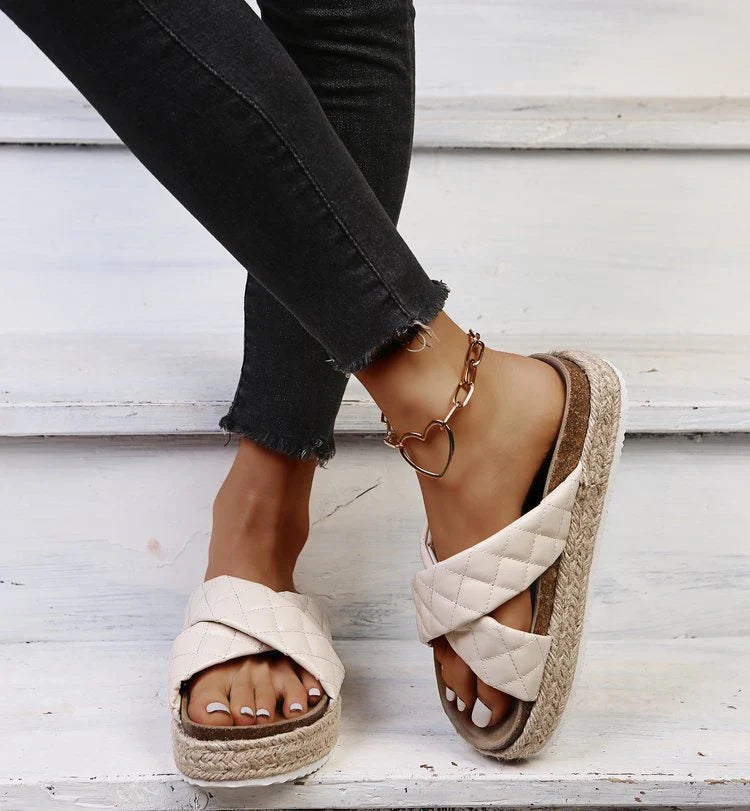 Elegant cross-toe platform sandals and slippers in a neutral creamy white hue, showcasing a contemporary and refined design for the discerning woman