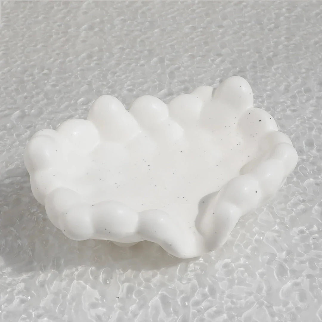 A ceramic soap dish with a whimsical cloud design, perfect for elevating your bathroom decor.