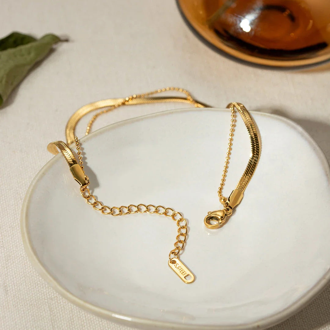 Exquisite 18K gold-plated double layer snake chain anklet with a durable stainless steel base, designed to elevate summer style with timeless elegance.