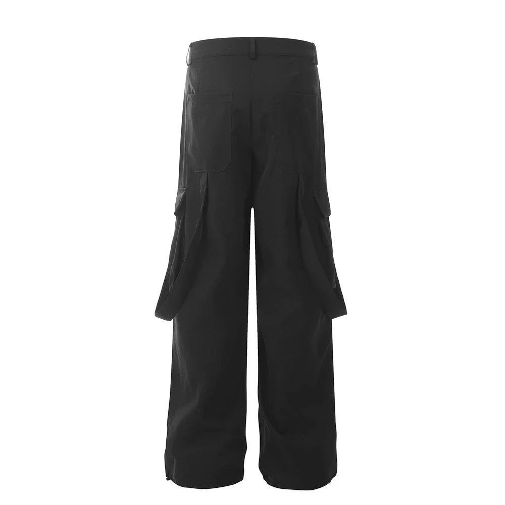 Stylish black pleated overalls with ribbon pockets, a versatile and refined menswear piece.