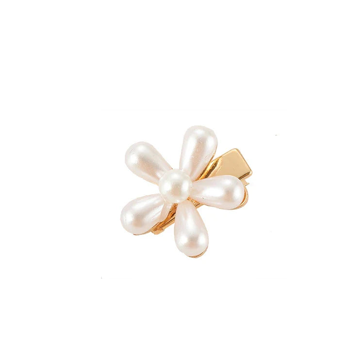 Elegant silver-toned hair clip with a beautiful pearl flower design, a timeless British-inspired accessory