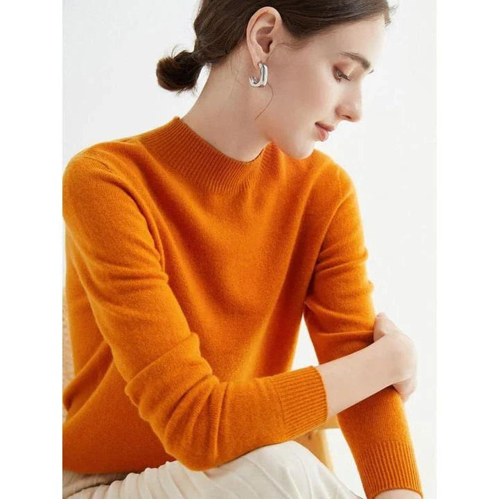 A woman wearing a luxurious Merino wool mock-neck jumper in a stylish autumnal outfit