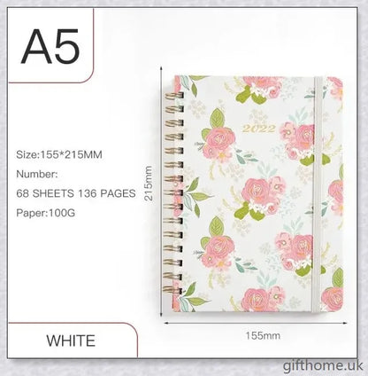 Premium A5 spiral-bound annual calendar notebook with a variety of stylish cover designs including blue art, pink roses, and colourful floral patterns