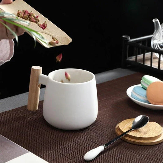 A stylish ceramic coffee mug with a colour block design and a coordinating wooden spoon