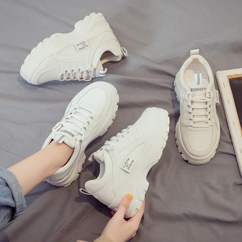 Fashionable women's casual trainers in beige and white colours, featuring a sporty yet chic design for everyday wear.