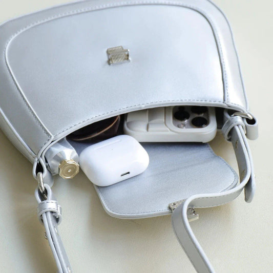 Elegant and versatile vegan leather shoulder bag with adjustable strap, flap cover, and interior pockets for modern British women