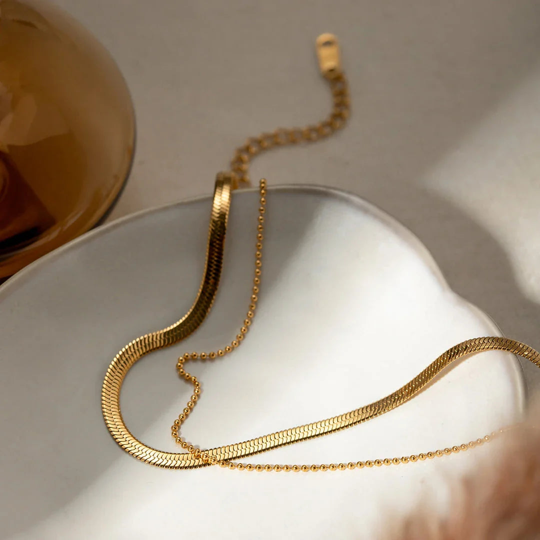Exquisite 18K gold-plated double layer snake chain anklet with a durable stainless steel base, designed to elevate summer style with timeless elegance.