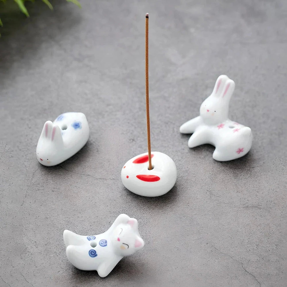 Charming Japanese-style ceramic incense holder with a playful rabbit and kitten design, perfect for creating a relaxing atmosphere in any room.