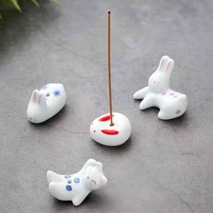 Charming Japanese-style ceramic incense holder with a playful rabbit and kitten design, perfect for creating a relaxing atmosphere in any room.