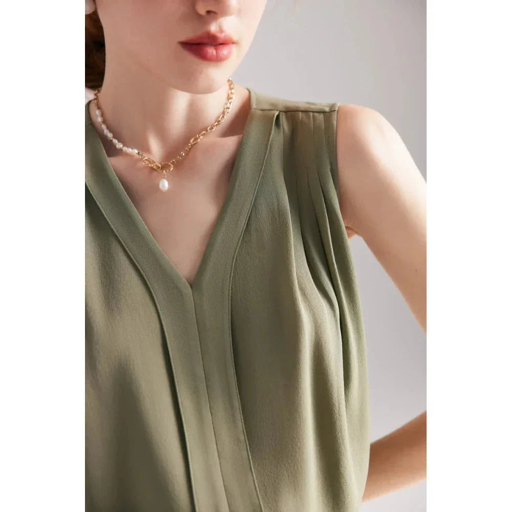 Elegant sleeveless silk blouse in a vibrant blue colour, designed for a sophisticated summer style