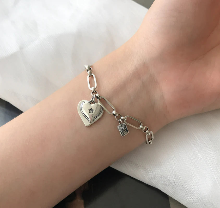 Elegant sterling silver bracelet with a delicate heart charm, a timeless accessory for the modern British woman.
