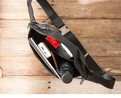 Premium cowhide messenger bag in black, featuring a spacious interior, adjustable shoulder strap, and sleek, minimalist design