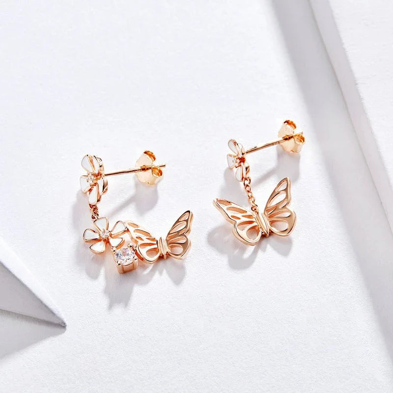 Pair of silver earrings featuring a butterfly-shaped floral design with sparkling white crystals, inspired by the enchanting Forest Series