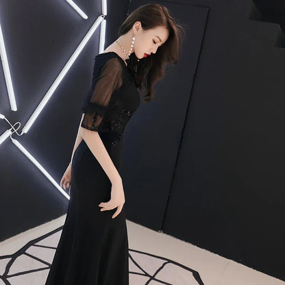 Elegant black evening dress with middle-length sleeves, perfect for formal occasions in the UK