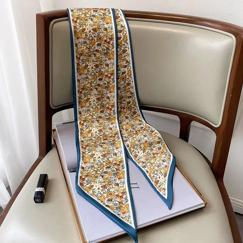 Elegant floral print polyester scarf with a soft, cotton-like texture for versatile seasonal wear