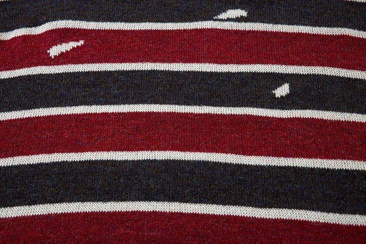 A cosy and stylish jumper featuring a patchwork design with contrasting stripes in a classic British colour palette.