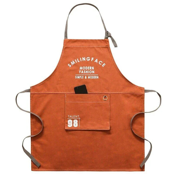 A stylish and practical Nordic-inspired canvas barista apron with a spacious front pocket and adjustable neck strap for a comfortable fit.