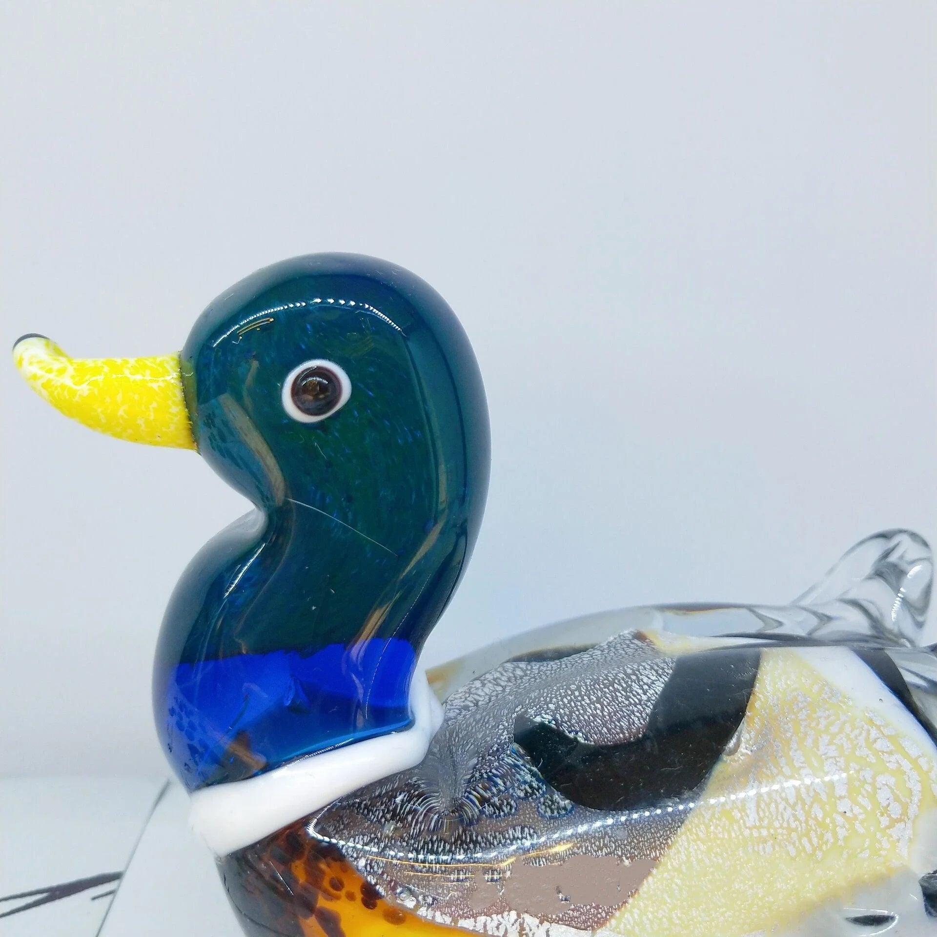 Handcrafted glass ornament in the shape of a Mandarin duck with vibrant colours and intricate details