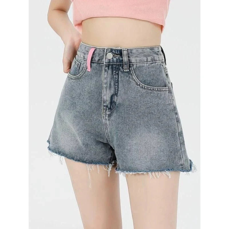 Stylish high-waisted denim shorts with subtle embroidery, perfect for summer fashion