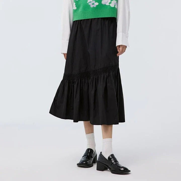 Elegant mid-length black skirt with an A-line silhouette, natural waistline, and unique irregular hemline, perfect for the modern British woman's wardrobe