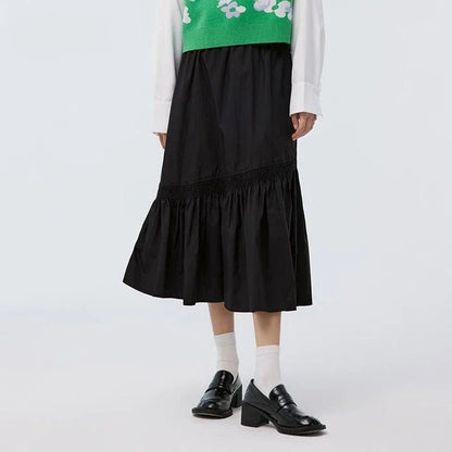 Elegant mid-length black skirt with an A-line silhouette, natural waistline, and unique irregular hemline, perfect for the modern British woman's wardrobe