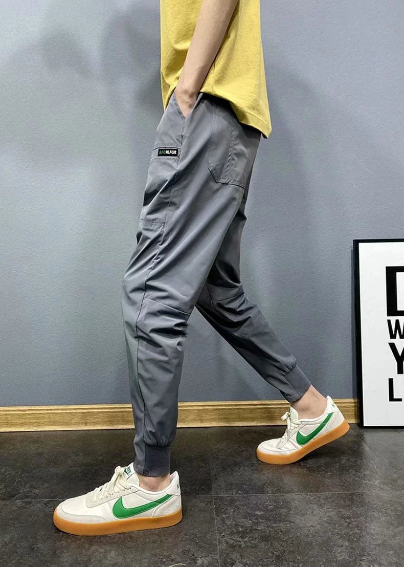 Premium slim-fit drawstring joggers in black and grey, featuring a tailored silhouette and adjustable waistband for a polished, comfortable look.