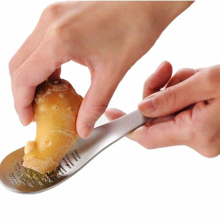 Premium stainless steel multi-purpose grater with ergonomic handle for easy grating and shredding in the modern British kitchen