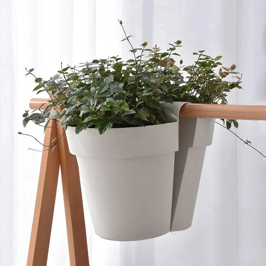 Stylish double-sided hanging rail planter in white, designed to display flowers and plants on both sides of a railing or surface