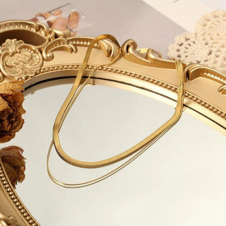 Elegant double-layered necklace in lustrous gold finish, made of premium stainless steel for a versatile and durable accessory.