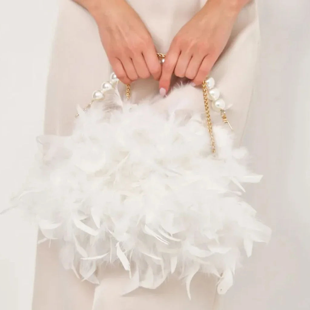 Elegant feather clutch purse with lustrous pearls, metal chains, and a top handle design